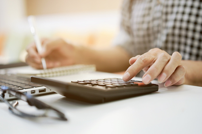 Where Should You Invest the Cash For Your Next Down Payment? close up grandmother hand press on calculator for counting about monthly expense or planning money management after retired concept