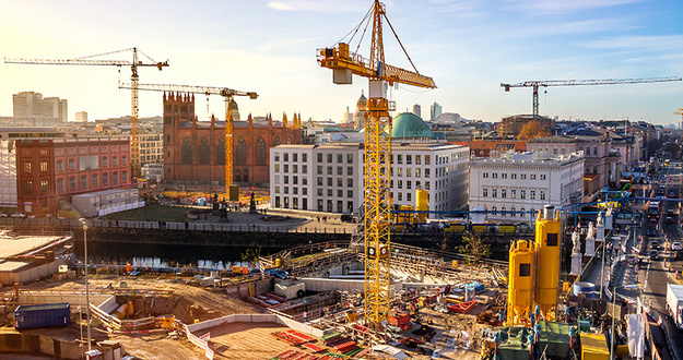 Urban Redevelopment & How to Capitalize on a Profitable Trend cranes in downtown area being redeveloped