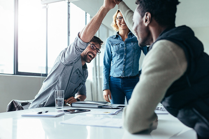 13 Habits the Vast Majority of Successful Leaders Share Two colleagues giving high five in meeting. Business people celebrating success in conference room.