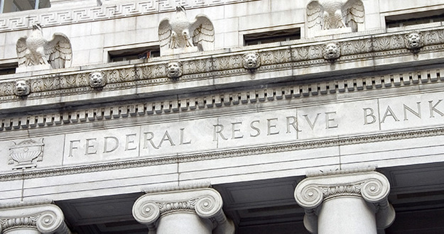 March Madness! Yield Curve Inverts and the Fed Throws in the Towel The facade of the Federal Reserve Bank.