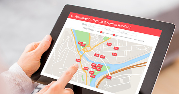 Summer 2019 Rent Report: Where Pricing Is Heating Up, Fizzling Out Person looking for places to stay on digital tablet