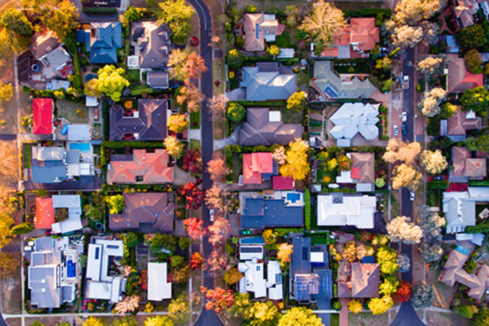 THIS Is the Best Time to Set Up an LLC for Your Investing Business Aerial view of a green leafy suburb