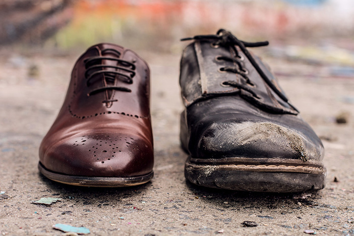 The Gender & Racial Wealth Gaps Are Real—Here’s How We Do Something About It Conceptual shooting of shoes. Old shabby shoes in comparison with new and expensive ones.