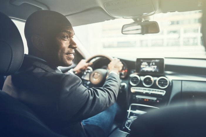 The (Nearly) No-Effort Way I Found My Last Multifamily Deal man driving luxury sedan looking out passenger window