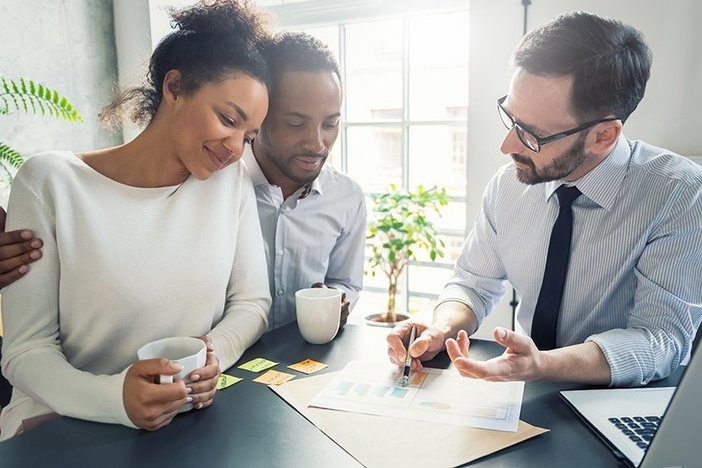 How to Invest in Real Estate With a Self-Directed IRA Family couple consultations with a lawyer or insurance agent.