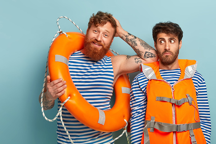 If 2020 Taught Us Anything About Money, It’s the Importance of THIS Pleased red haired man tired after saving people at beach, leans at shoulder of partner who looks surprisingly aside, work together at beach, have duty to watch sea, wear life vest