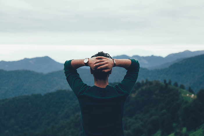 How To Survive When Your Spouse Doesn’t Believe In Your Dream man facing away from camera looking out at mountain range