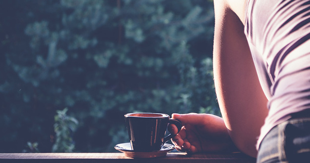 3 Ways to Handle Requests for Proof of Funds When You Don’t Have Any tight shot of woman leaning on deck rail drinking coffee overlooking backyard