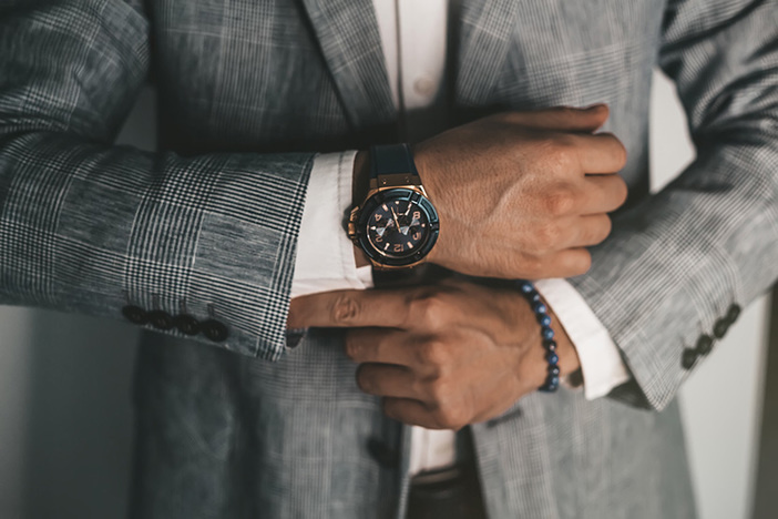 The Top 6 Ways Wholesalers NEED to Change How They Do Business (According to a Wholesaler) Closeup fashion image of luxury watch worn by male in gray suit