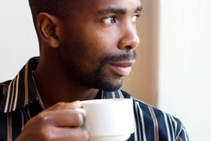Becoming a Real Estate Agent: Is It the Right Choice for You? african american man drinking coffee looking out a window