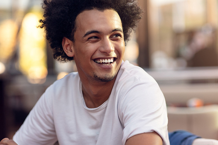 3 Things You Don’t Have to Think About With Turnkey Properties (& 3 Things You Do) Close up portrait of handsome cheerful african man smiling looking at camera