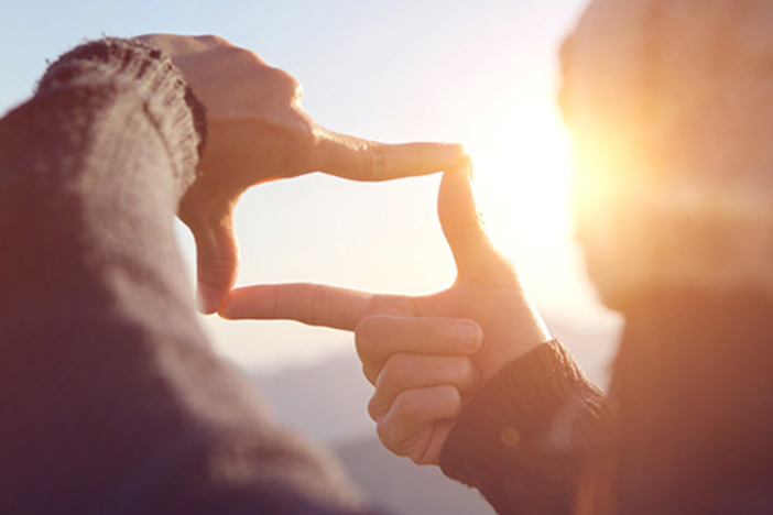 4 Tips for Recent College Grads Seeking Financial Freedom person making visual frame with fingertips conveying focus