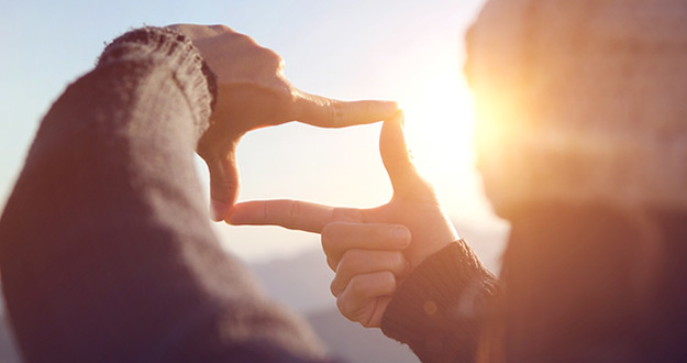 4 Tips for Recent College Grads Seeking Financial Freedom person making visual frame with fingertips conveying focus
